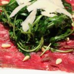 Carpaccio vom Rind mit Pinienkernen, Rucola und Parmesan