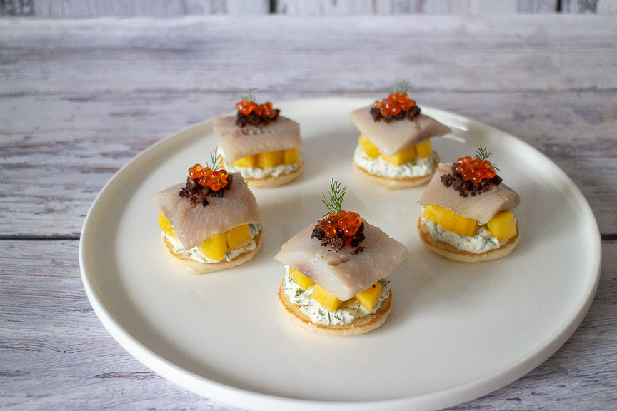 Matjes Blini mit Mango, Kaviar, Dill und Pumpernickel